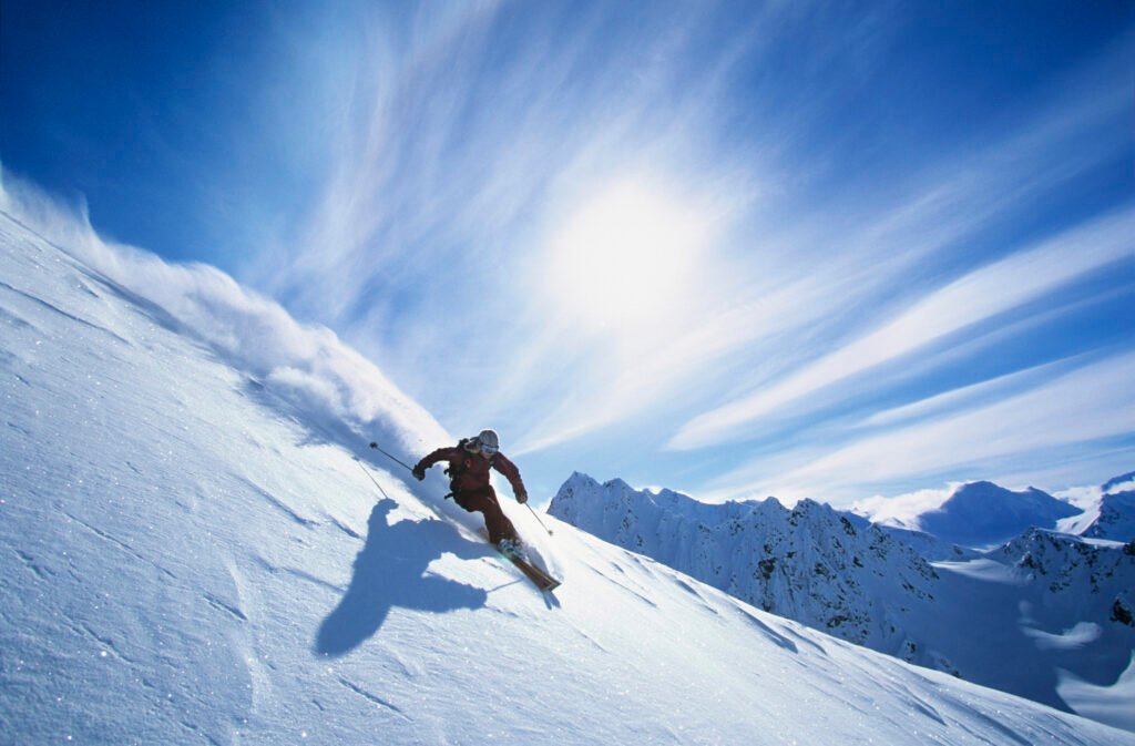 Full length of skier skiing on fresh powder snow in the Catskills, NY.